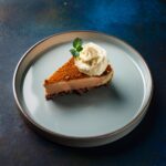 A creamy slice of carnivore cheesecake topped with a dollop of whipped cream